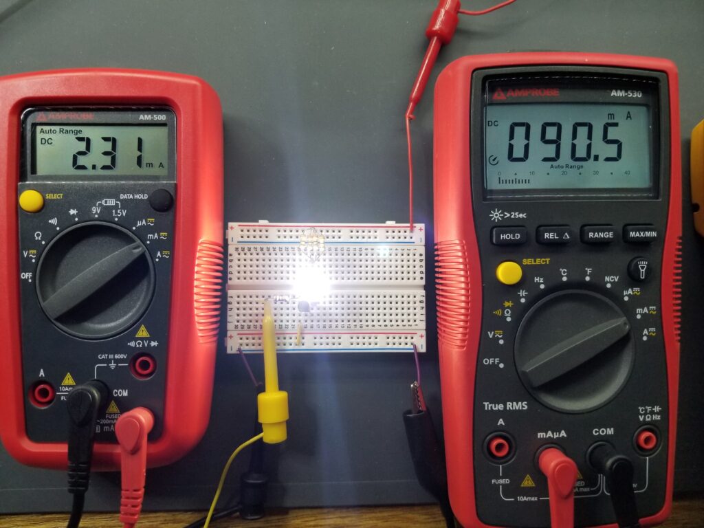 Transistor in saturation mode, base current on left, and collector current on right. LED is on.  
